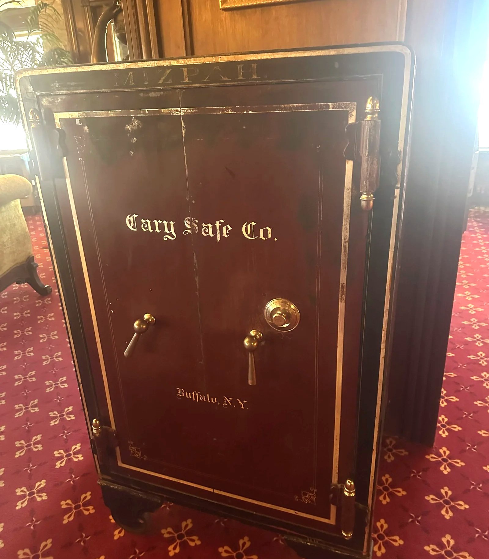 Antique Cary Safe Co. safe against dark wood paneling at the Mizpah Hotel